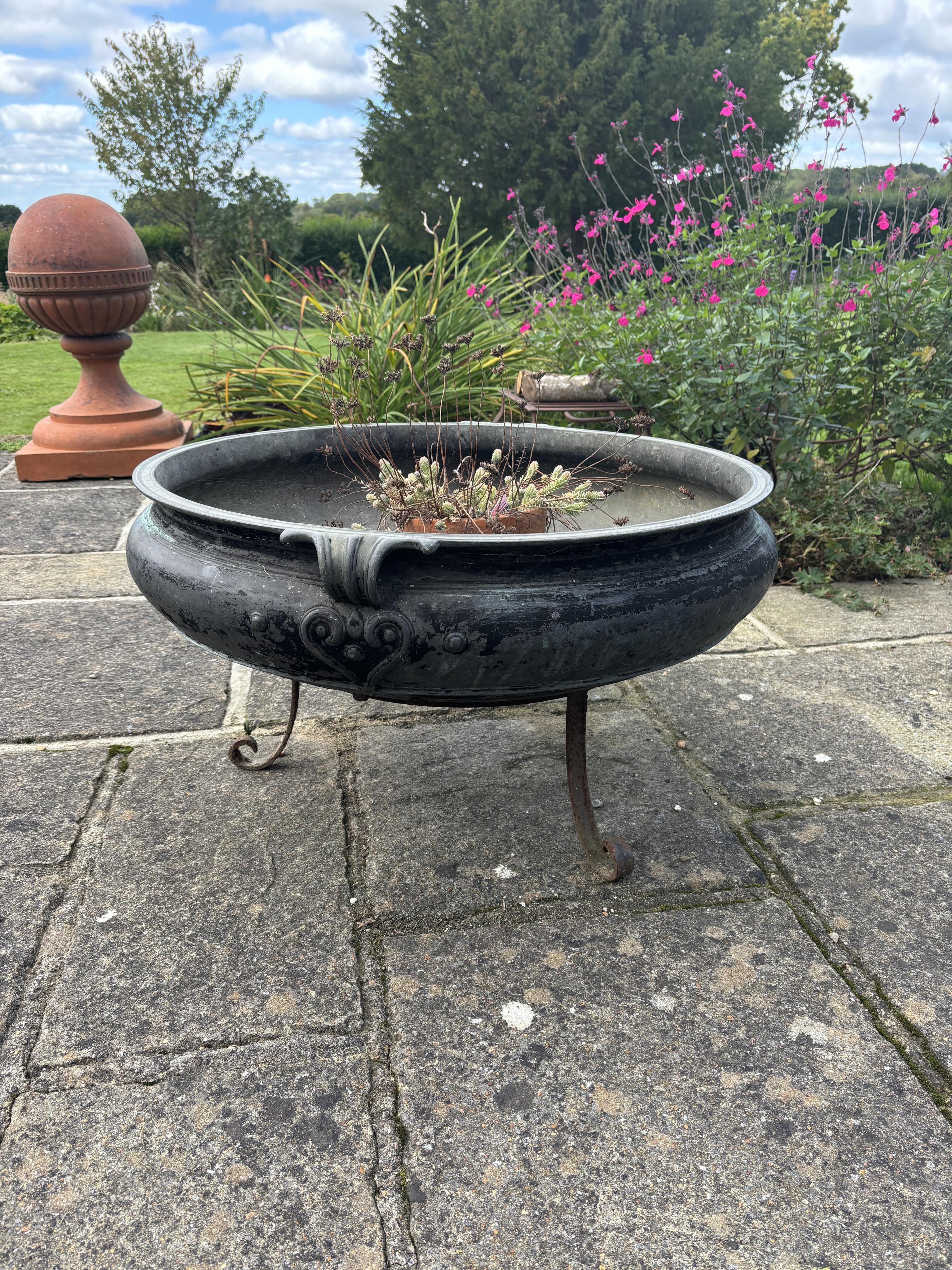 A large Indian bronze incense burner on wrought iron stand, width 79cm, 42cm high overall. one hole drilled. Condition - weathered, otherwise good